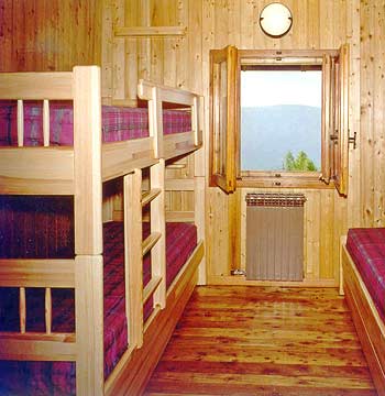 Inner view of a bedroom in the Rifugio L'Ermitage
